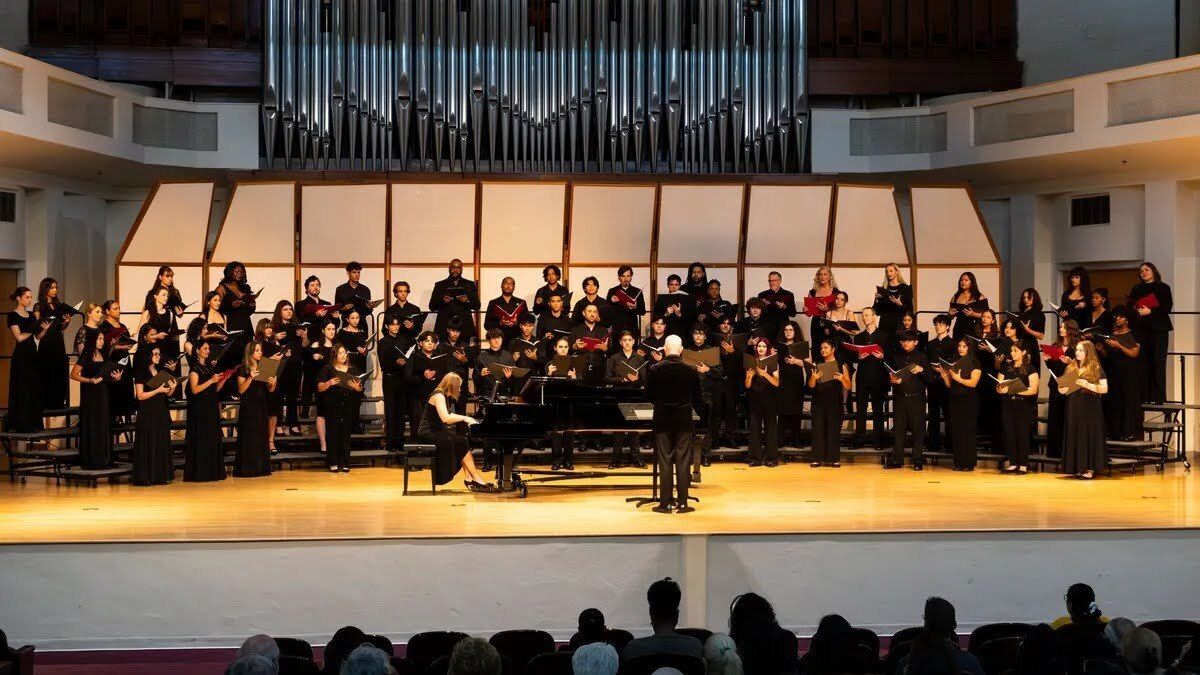 A large choir of High School Professional Choral Institute students perform side-by-side with Seraphic Fire on stage at the Wertheim Center for the Performing Arts.