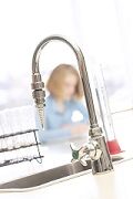 High Handled Faucet with Woman in Background