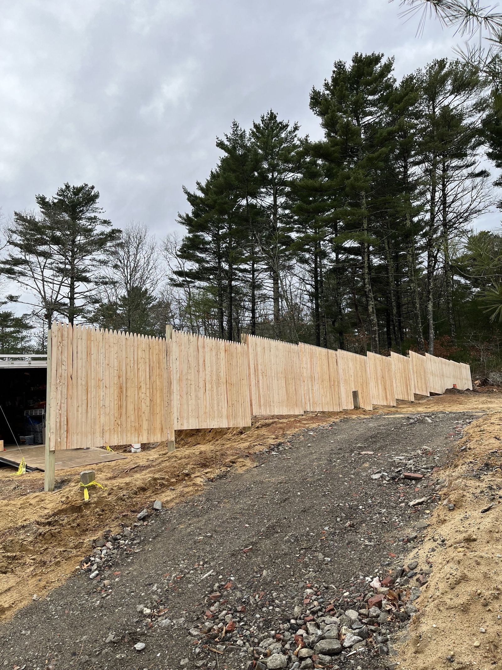 A photo showing a wood privacy fence outside