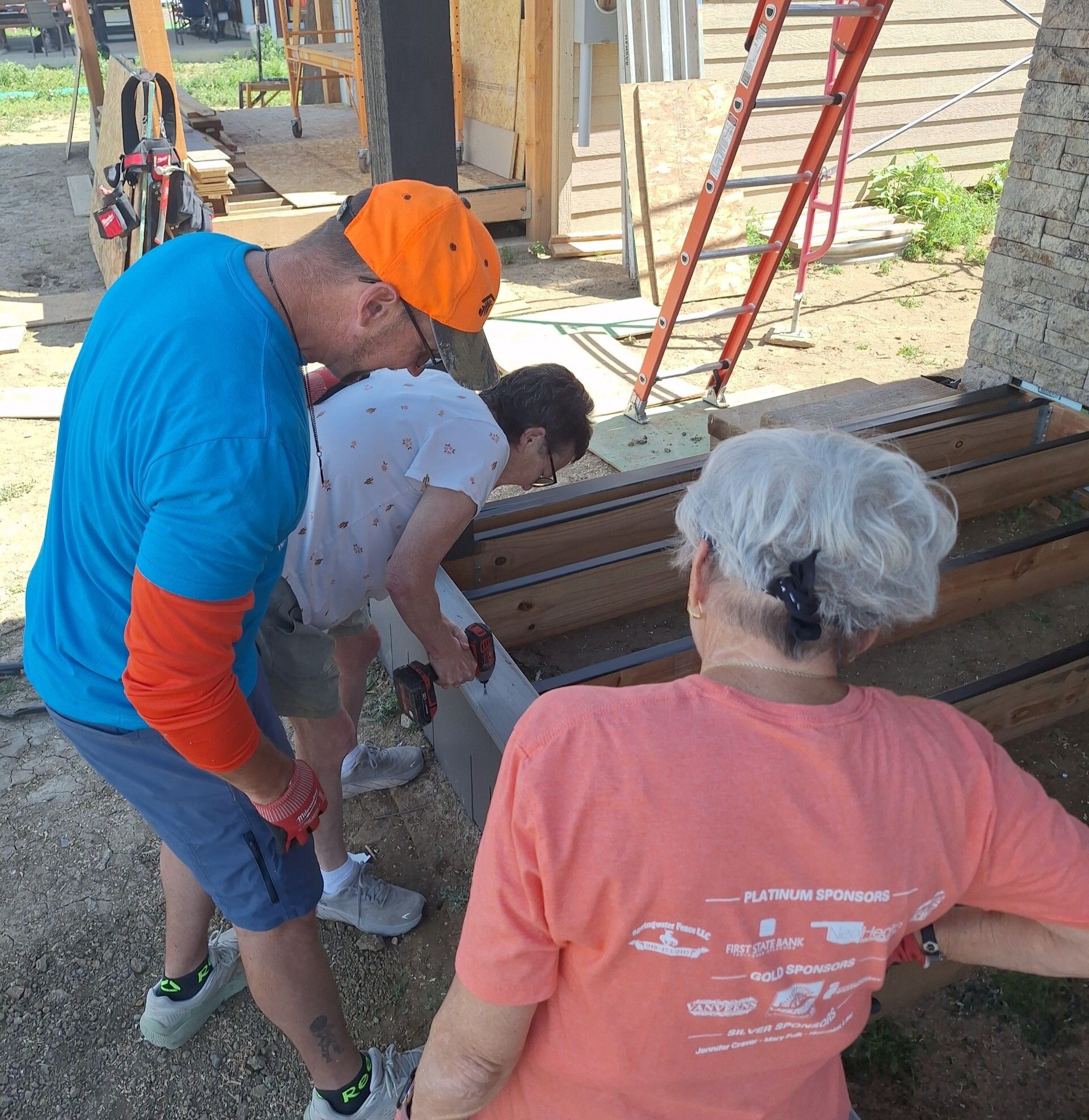 Trilby nailing her front porch with volunteer and staff.