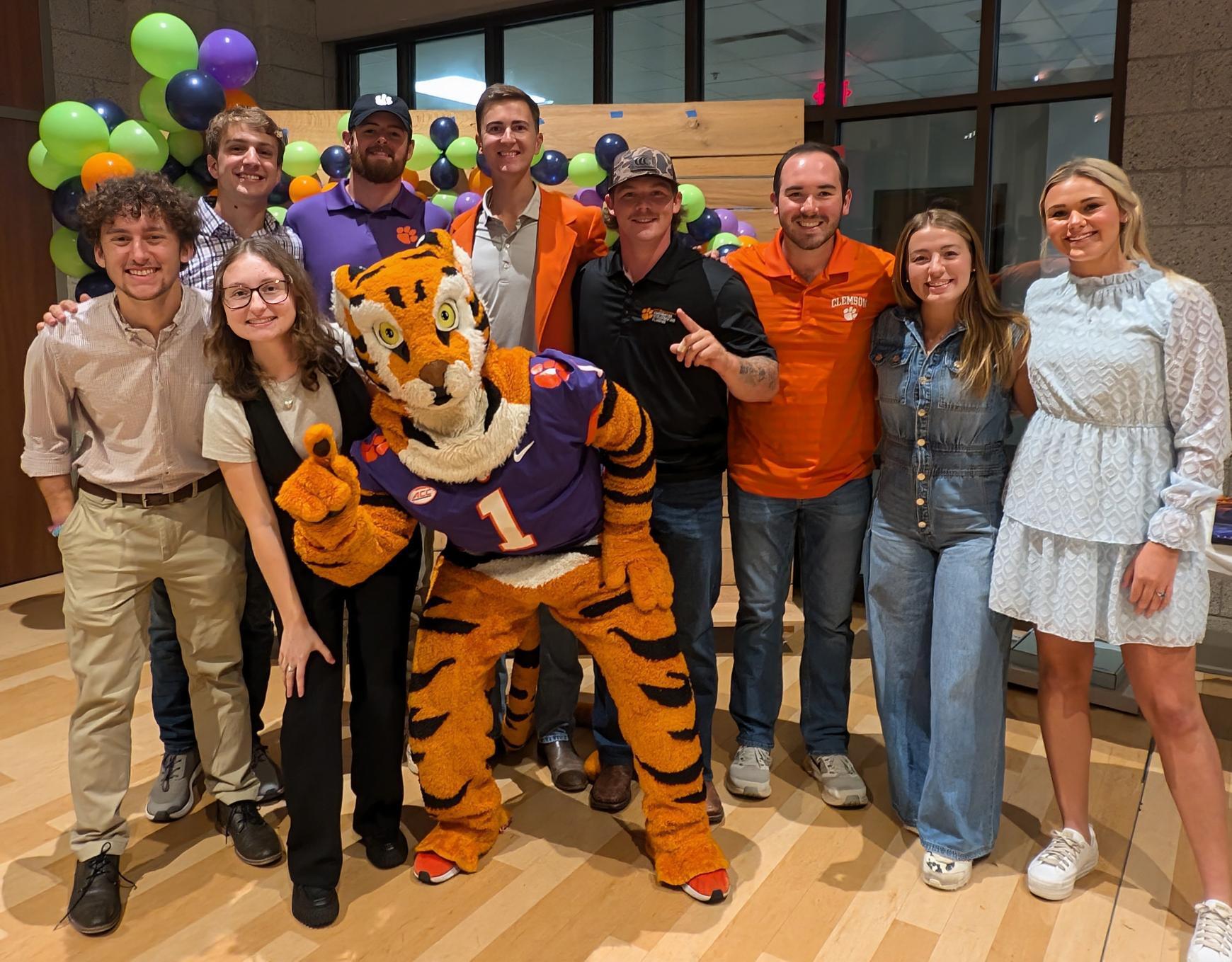 Nine students representing the Campus Chapter leadership team pose with the Clemson Tiger mascot