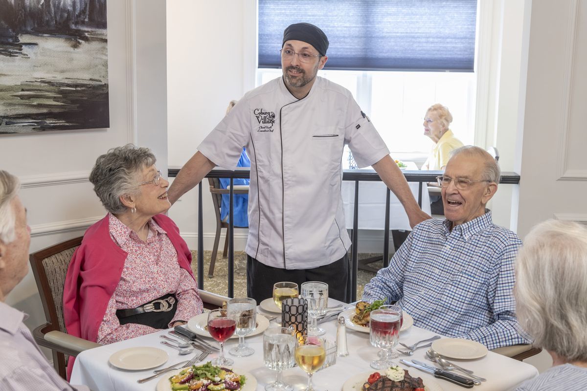 Chef talking with residents in the dining room