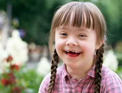 Girl with down syndrome smiling 