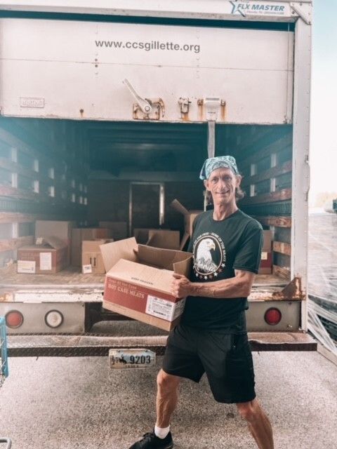 Tony unloading a truck of boxes.