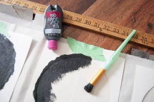 Black paint on crescent moon stencils.