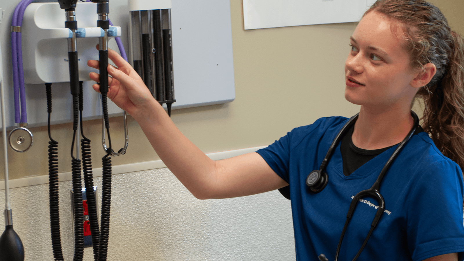 nursing student reaching for tools