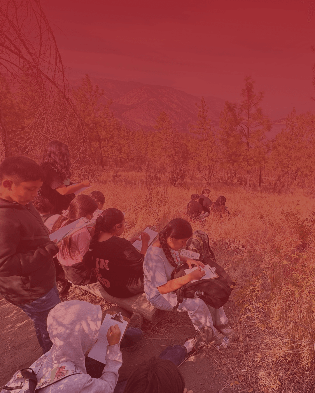 image of a red gradient over a picture of students journaling in nature