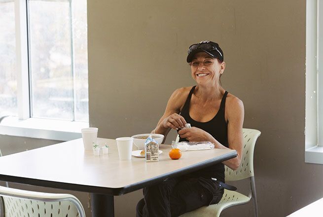 Woman eating in the cafeteria.