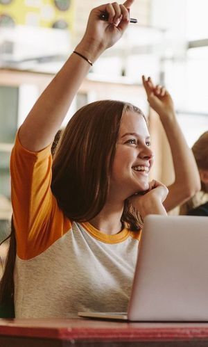 Girl raising her hand in a classroom