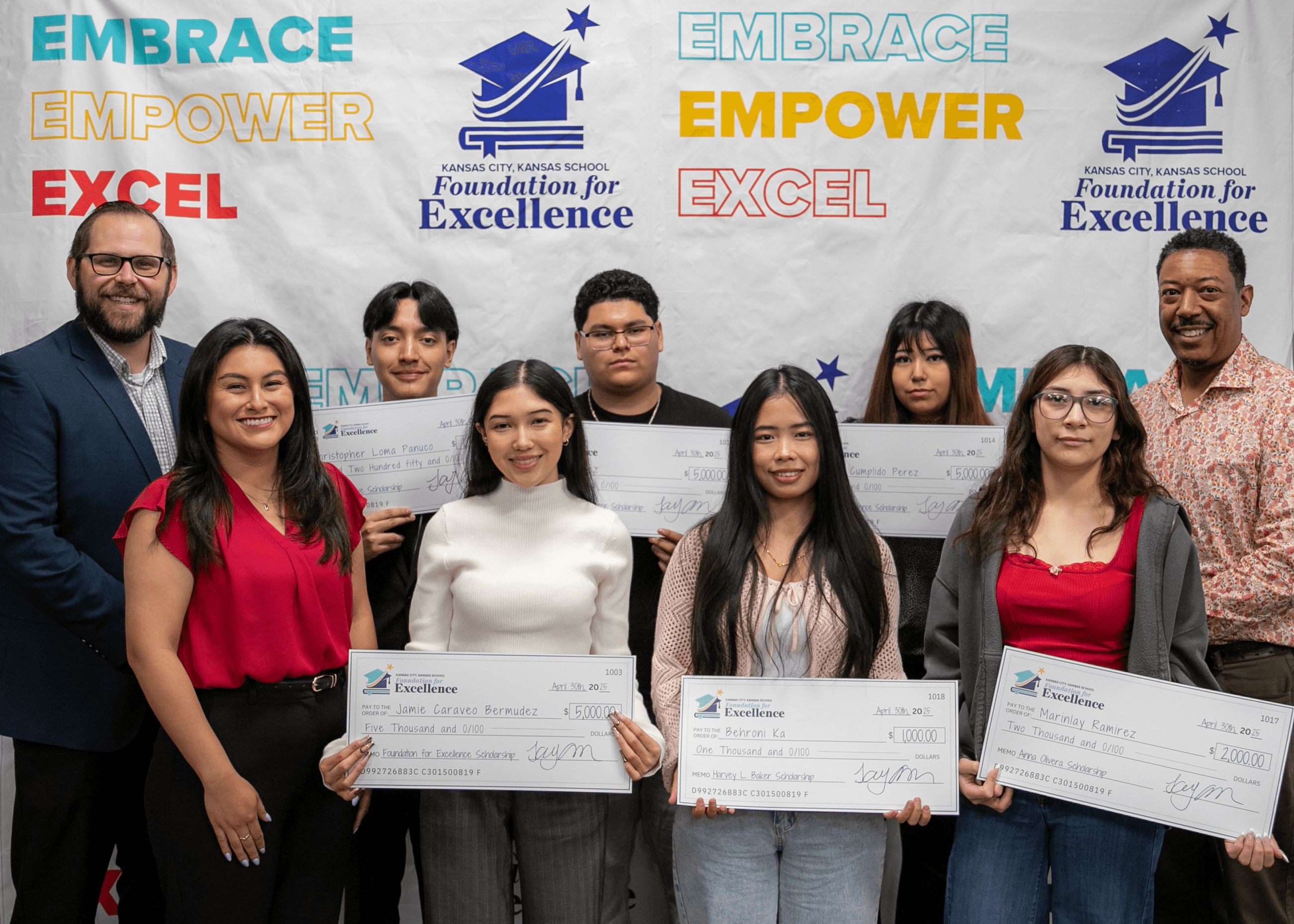 Students holding scholarship checks