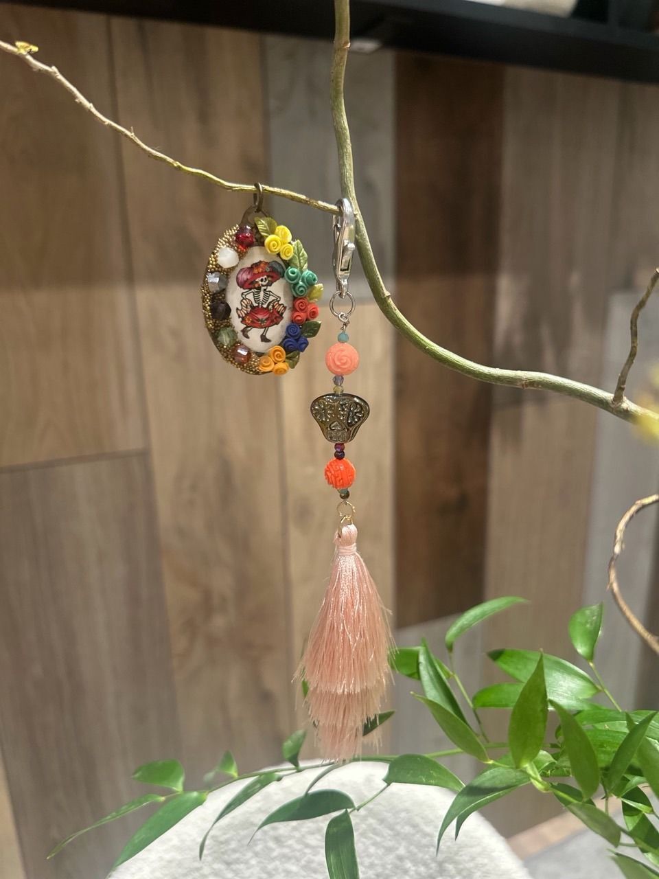 Colourful Day of the Dead skeleton locket and beaded keychain charm with a pink tassel.