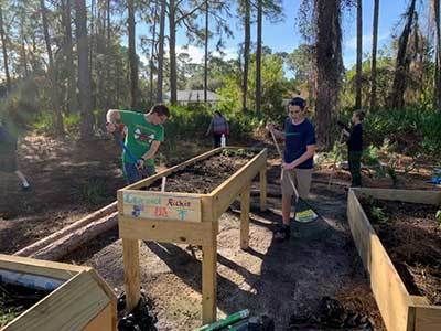 Kids working in a garden.