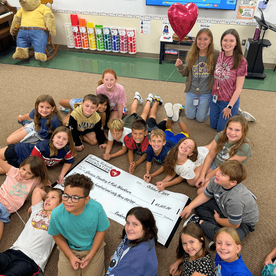 Children in classroom gathered around a donation