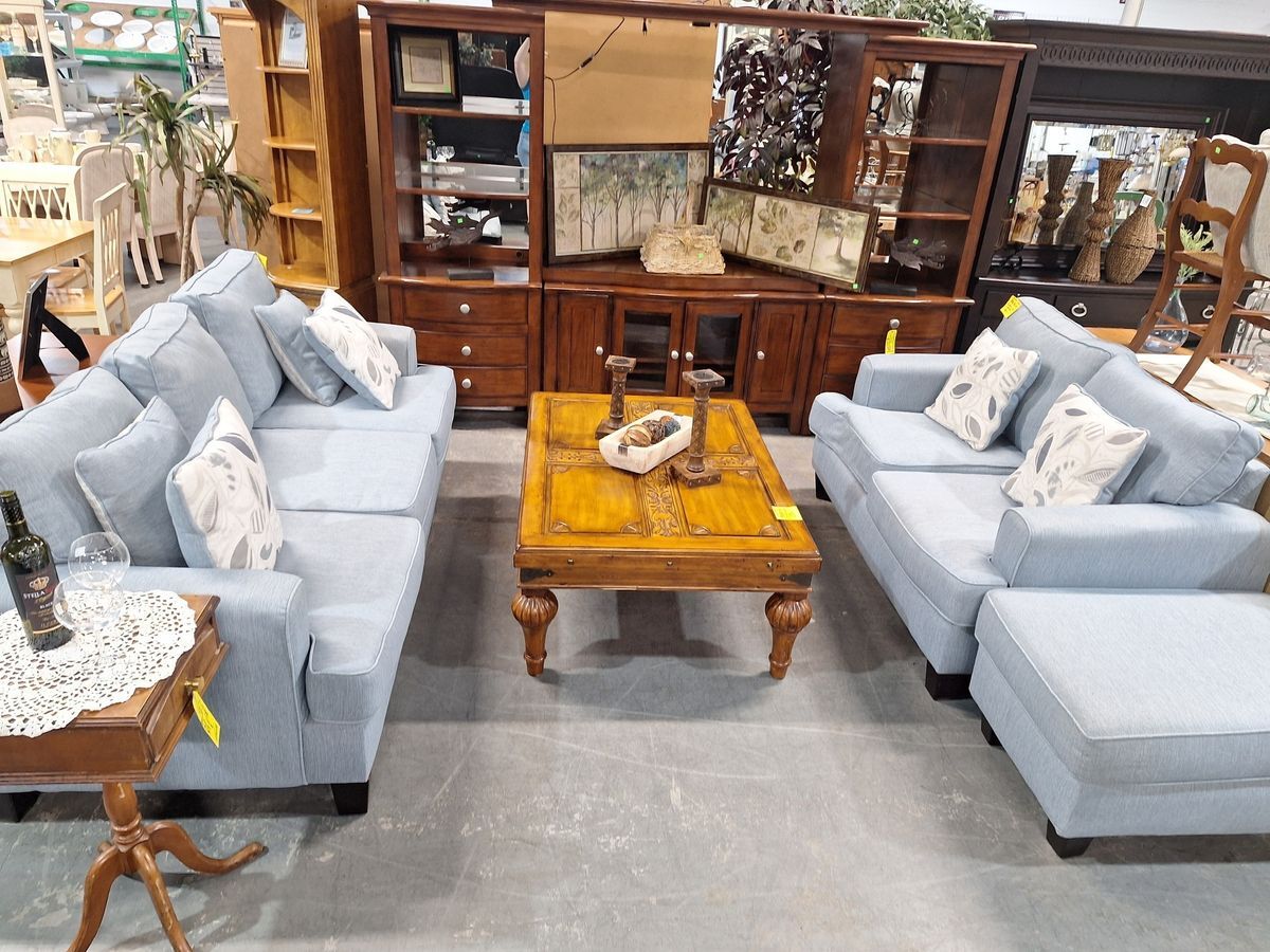 Cozy light blue upholstered living room set with two sofas and accent pillows, available at Habitat ReStore Zephyrhills