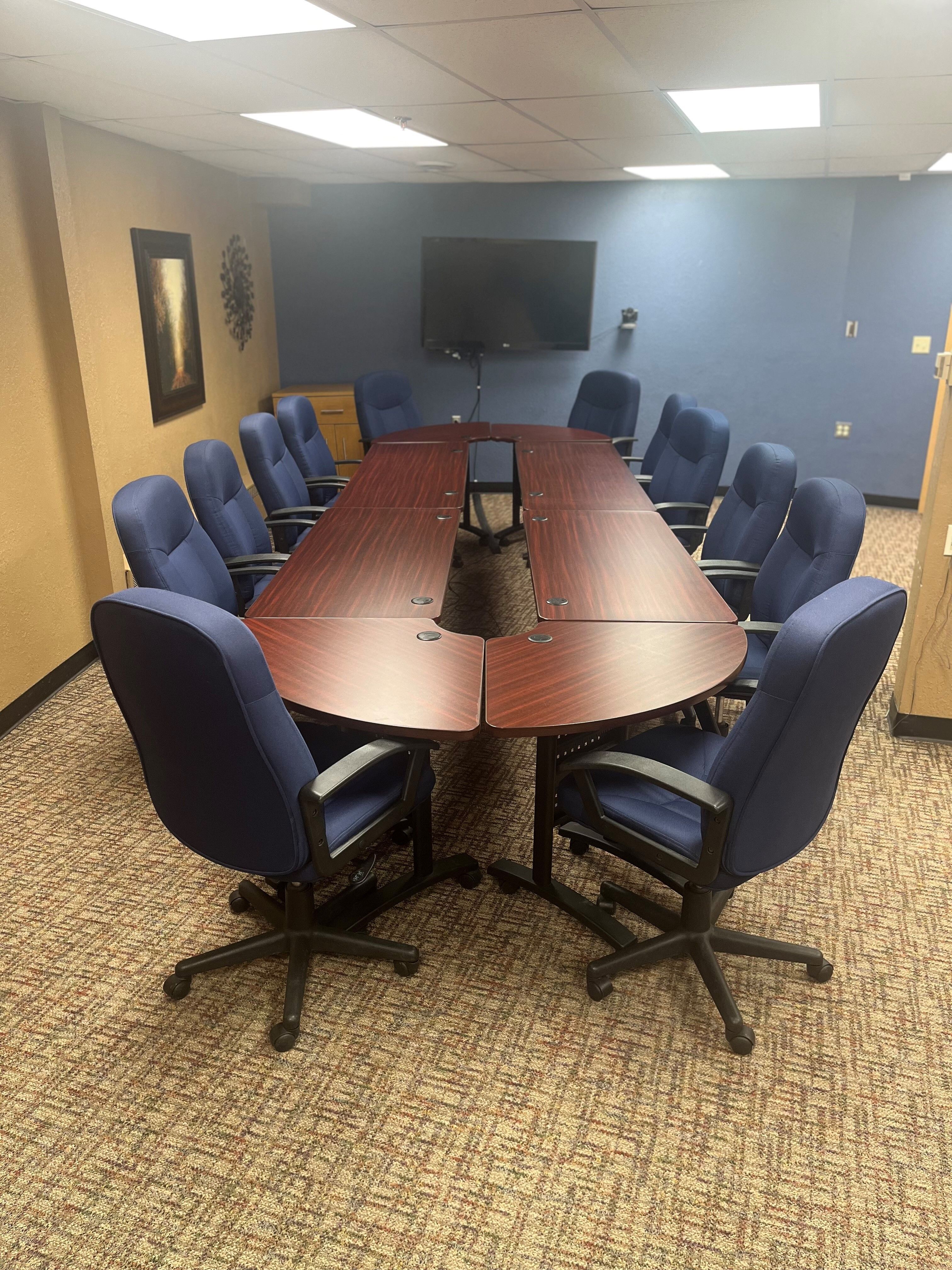 Image of a boardroom table with chairs.