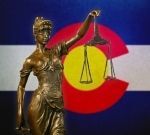 Lady justice in front of Colorado flag