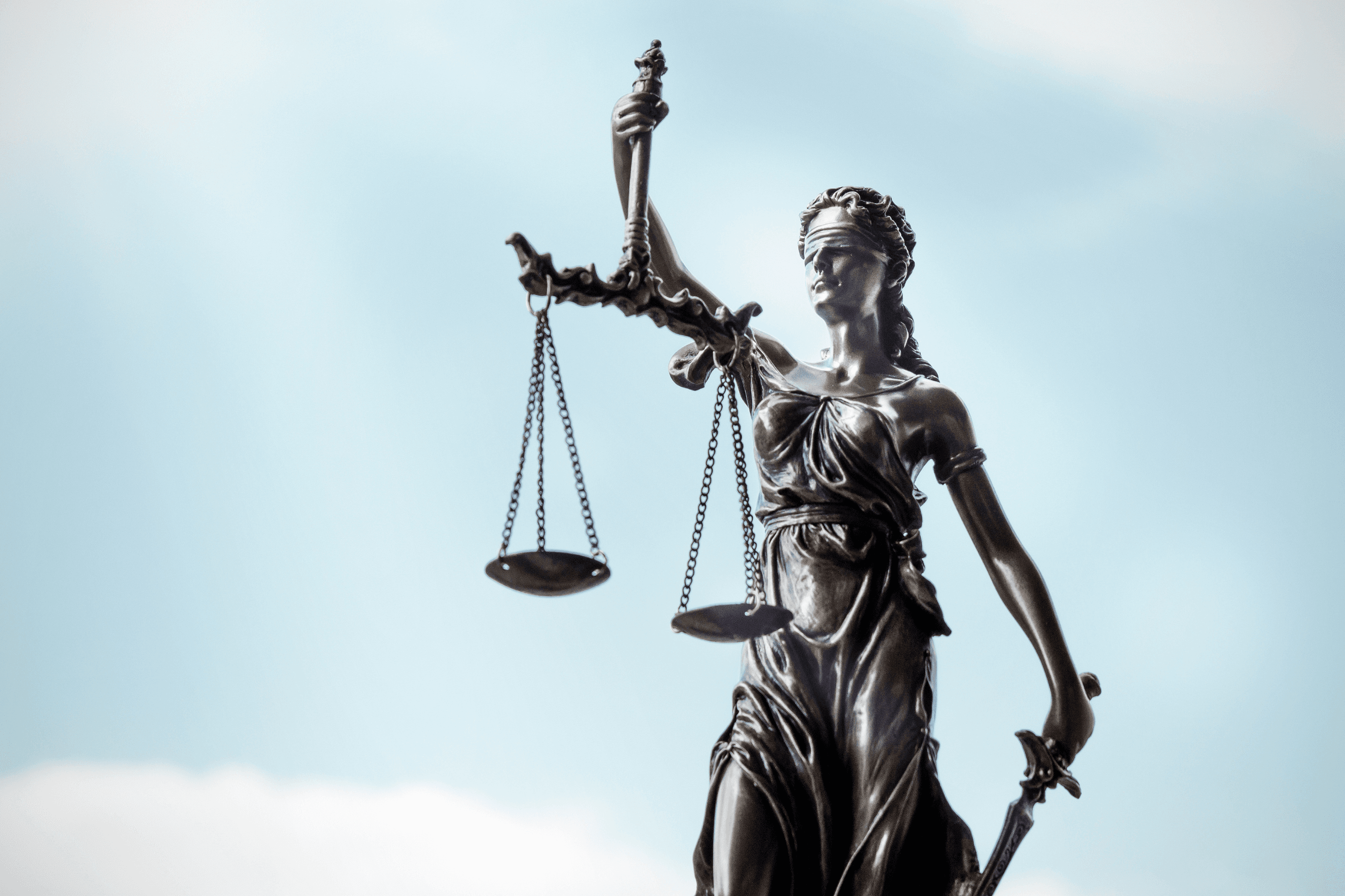 Image of lady justice with blue sky background