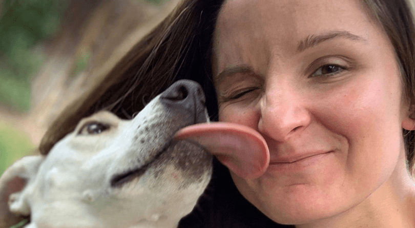 Dog Licking Face of Woman