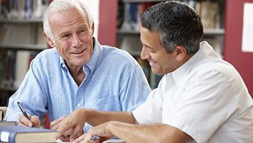 Two men learning together.