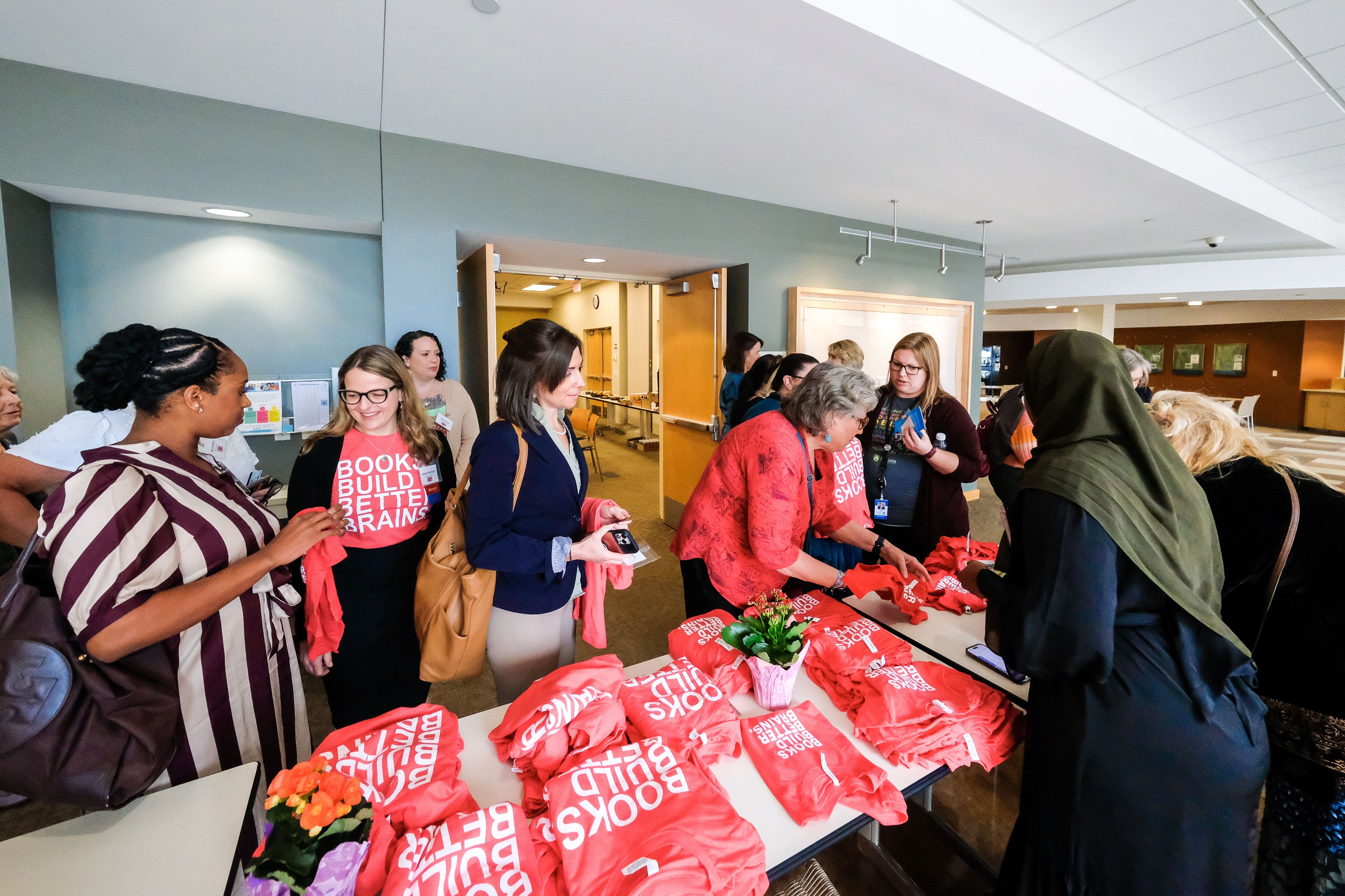 People wait in line to buy Books Build Better Brains t-shirts