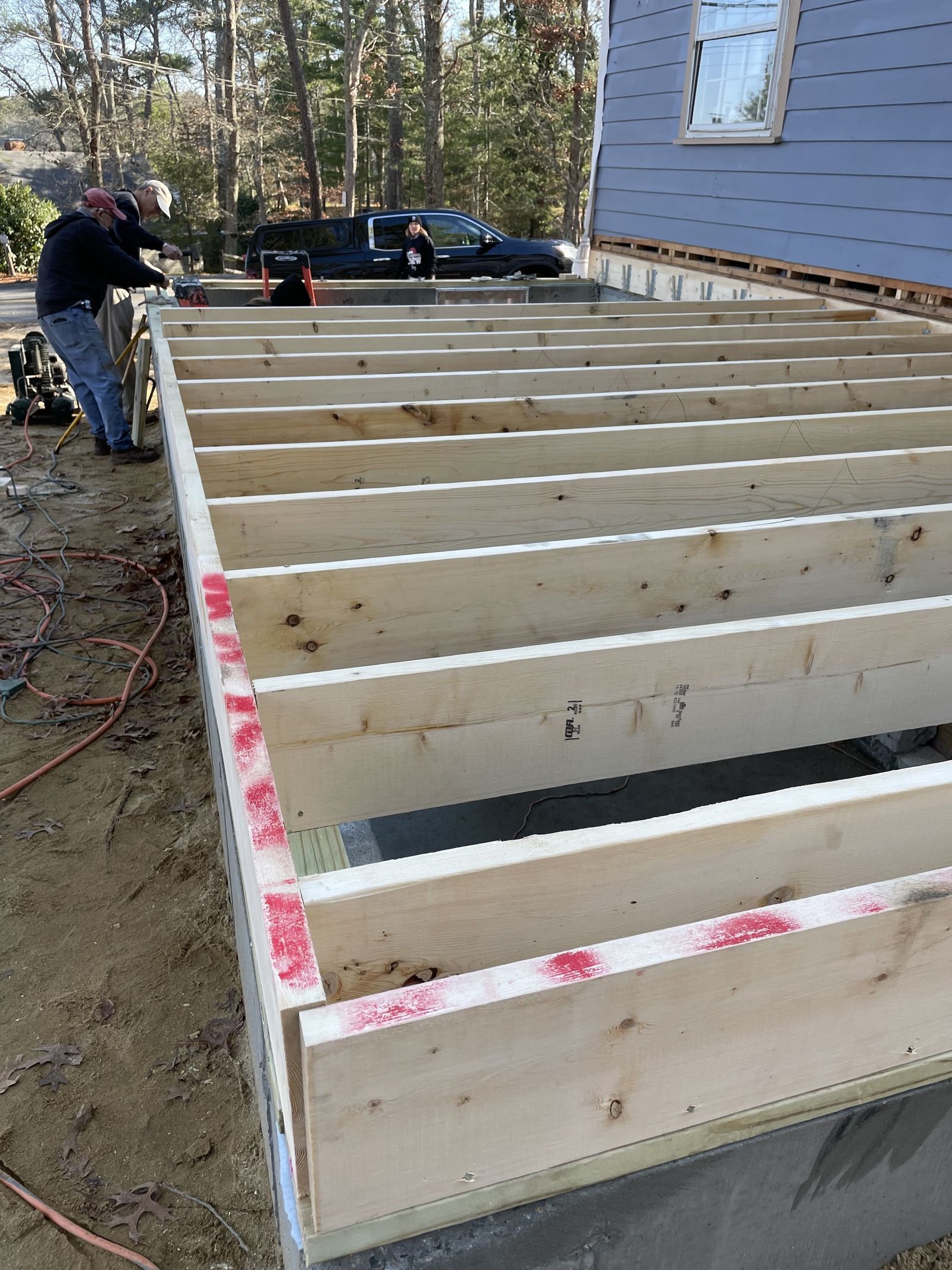 Photos of floor joists and framing installed for new addition