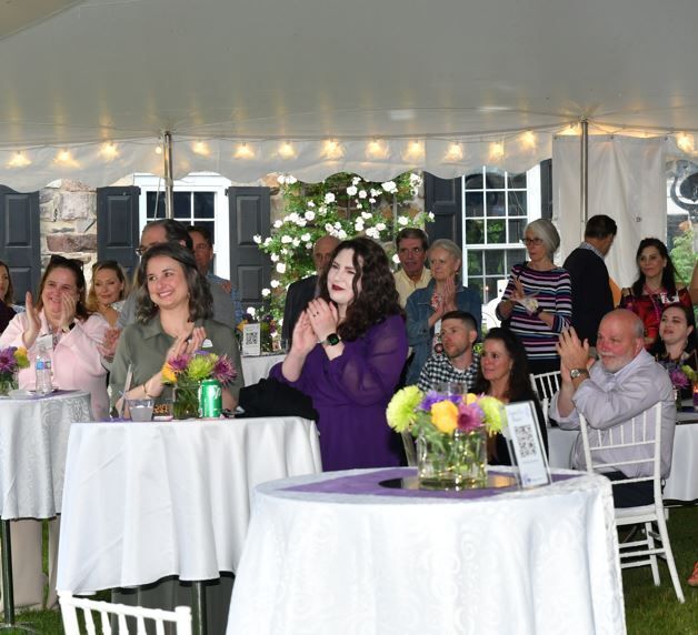 Guests attending a Sunset Soiree listen to impact speakers before they enjoy a sunset on the Delaware River.