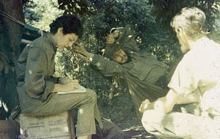 Celia Sanchez taking notes from Fidel Castro