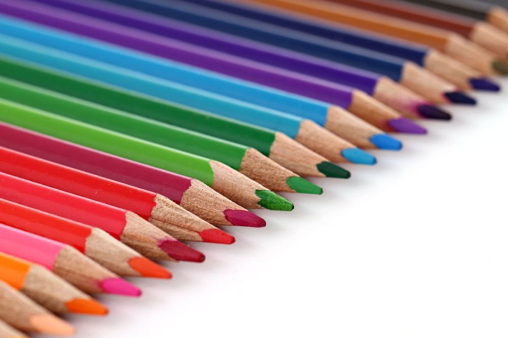 Colored pencils lined up in rainbow color order