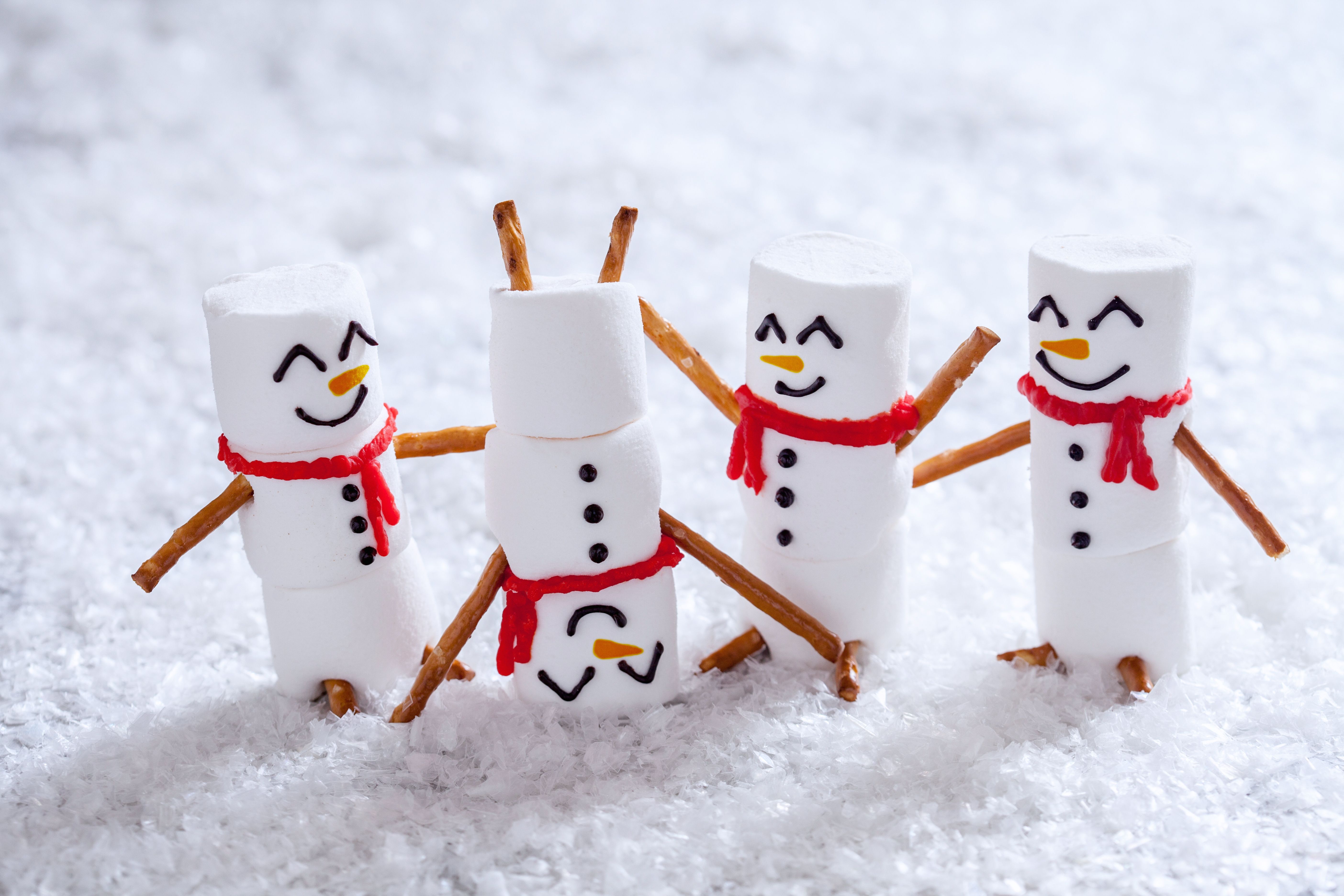 Marshmallow snowmen playing in coconut snow