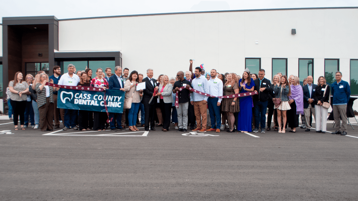 group of people at ribbon cutting