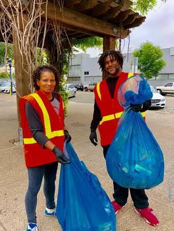 Wheels of Change volunteers picking up trash.