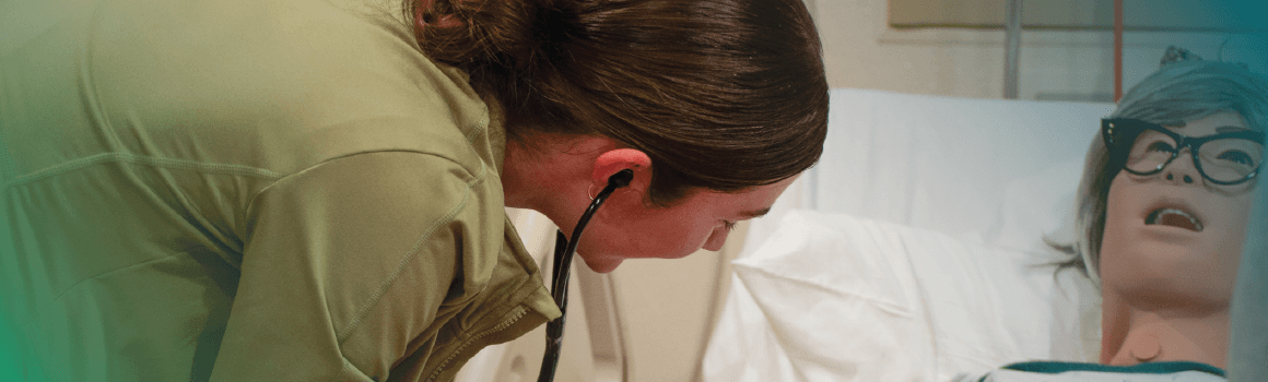 nursing student taking blood pressure in simulation lab