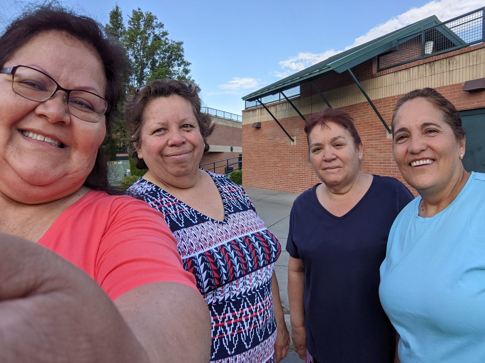 Four Hispanic women standing looking at the camera