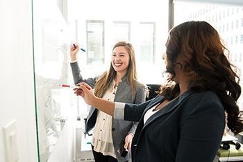 print employees meeting at whiteboard