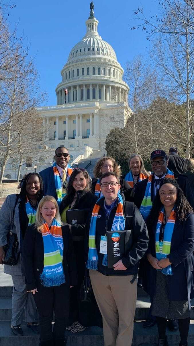 Participants from Habitat organizations across South Carolina stand in front of the Capitol building before heading out to speak with South Carolina's legislators.