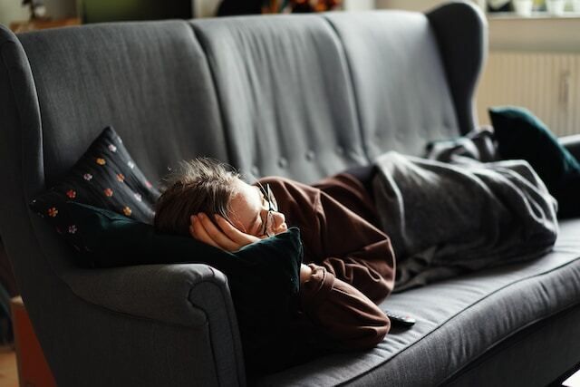 Lonely person lying on a couch