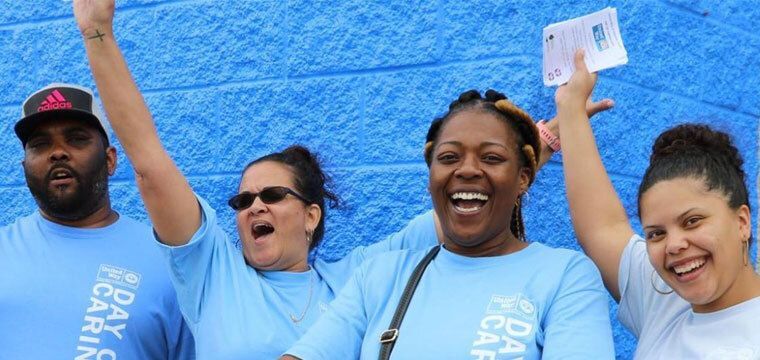 Group of people raising hands outside