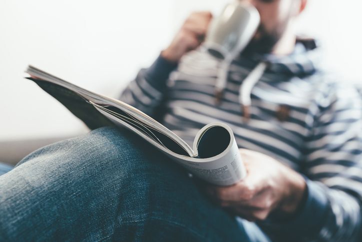 Person reviewing custom print marketing materials including brochures and direct mail