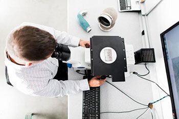 Person looking at laptop parts.