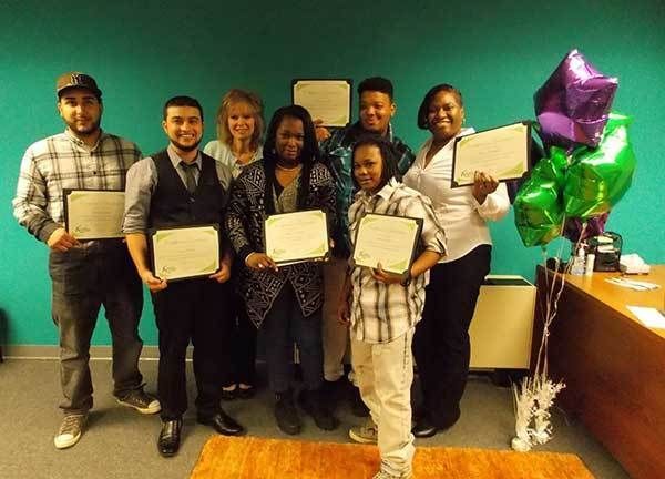 People smiling with awards.