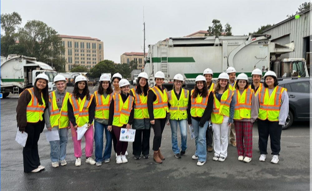 Zero waste interns in yellow high visibility vests.