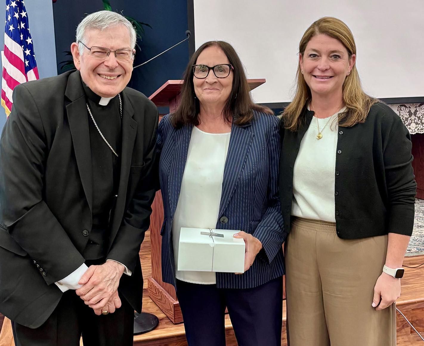 Susan Demes, center, retiring St. Ann School principal, poses with Bishop Emeritus Gerald M. Barbarito and Katie Kervi, diocesan superintendent of schools