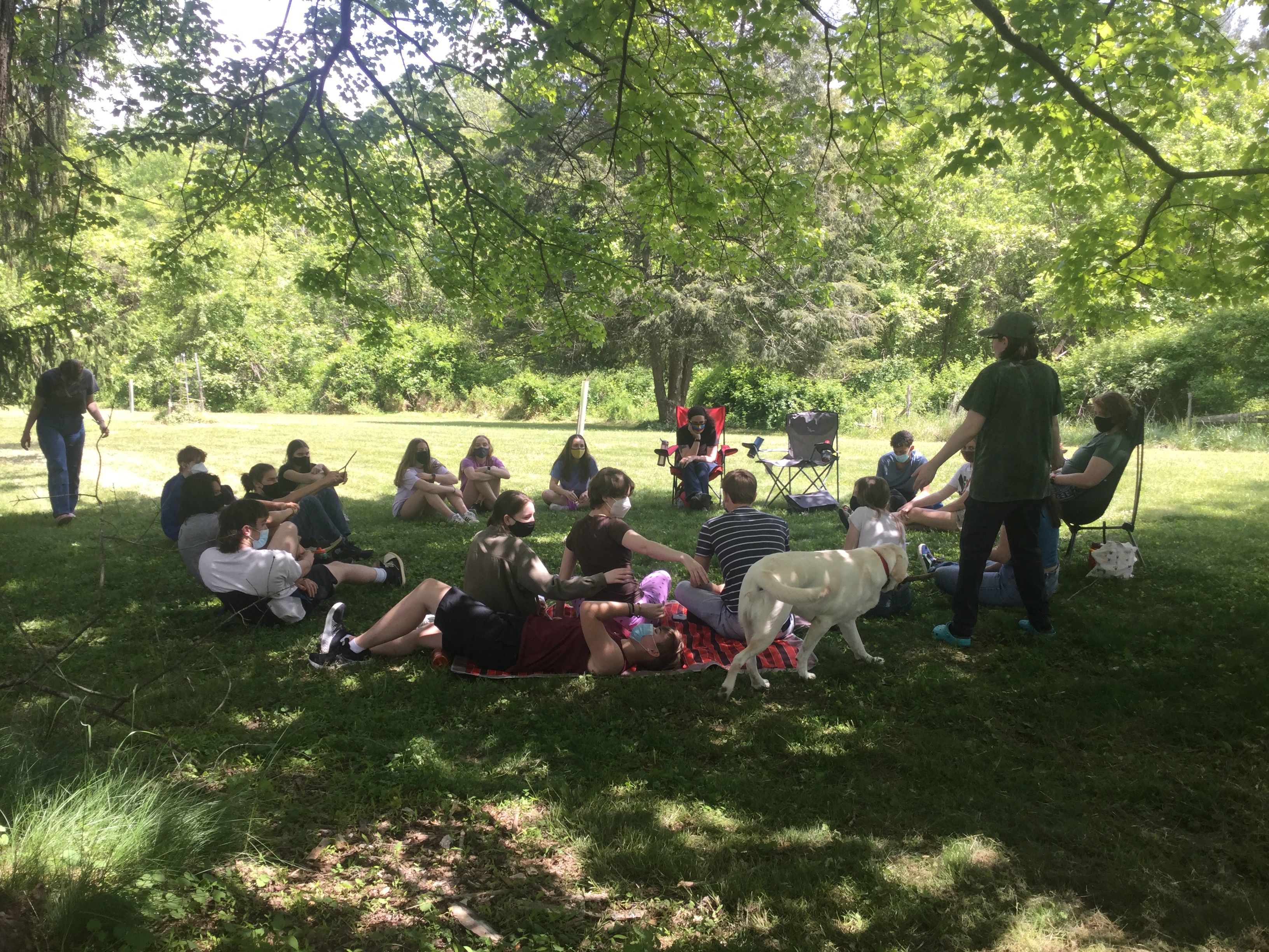 YFs sit in a circle at the BYM Office's backyard playing games