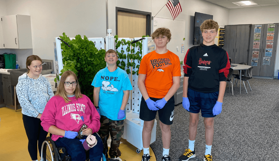 Students in gym smiling for a photo