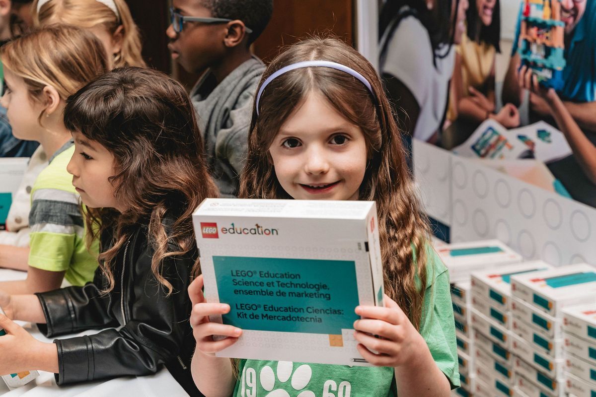 Student holding LEGO Education Science kit