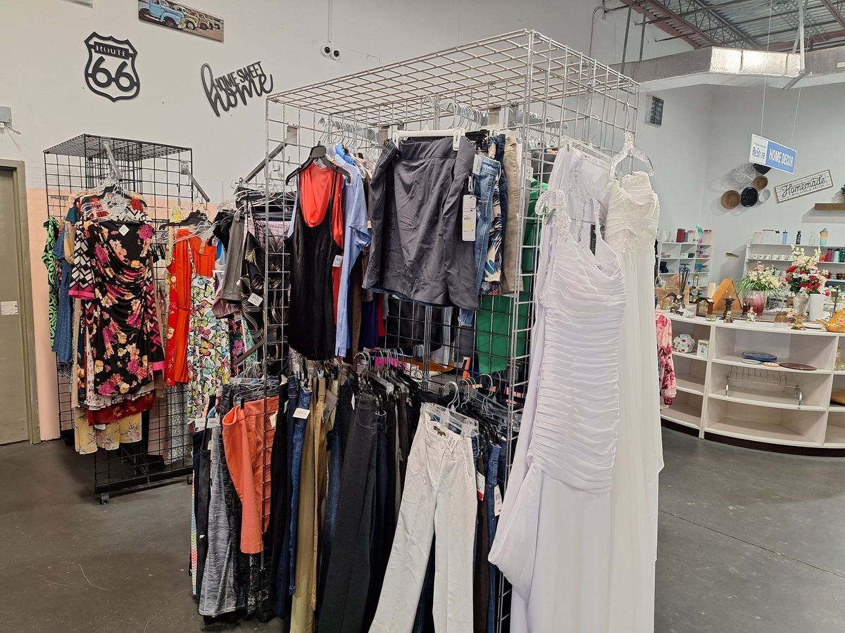 Wide selection of secondhand women’s clothing including dresses, pants, and tops at Habitat ReStore Zephyrhills thrift clothing section