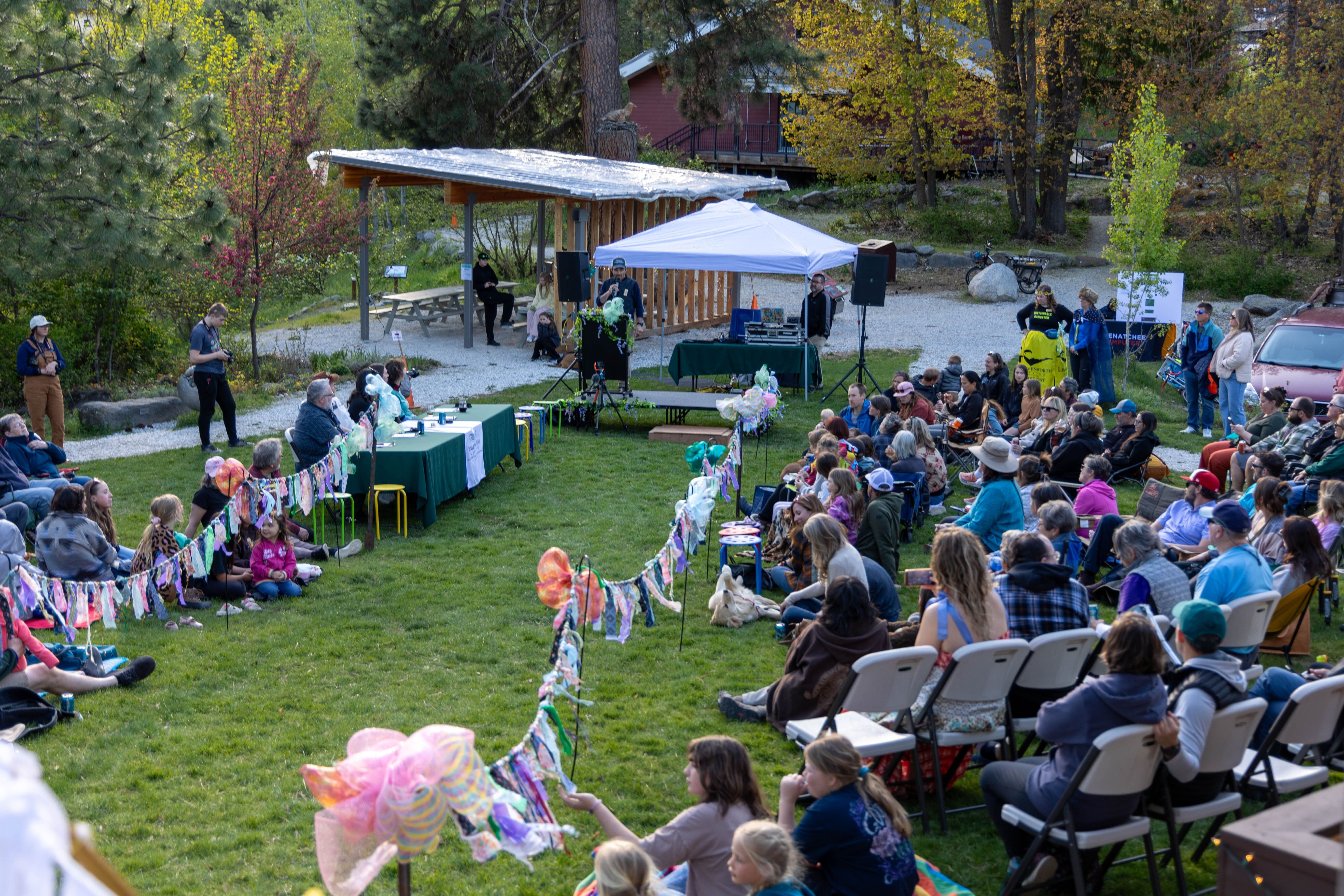 Photo of the 2026 Trashion Show runway on the Wenatchee River Institute's River Haus lawn.