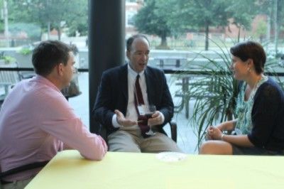 A picture of three people having a conversation at the conference.