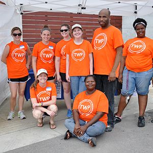 Group of volunteers in bright orange shirts