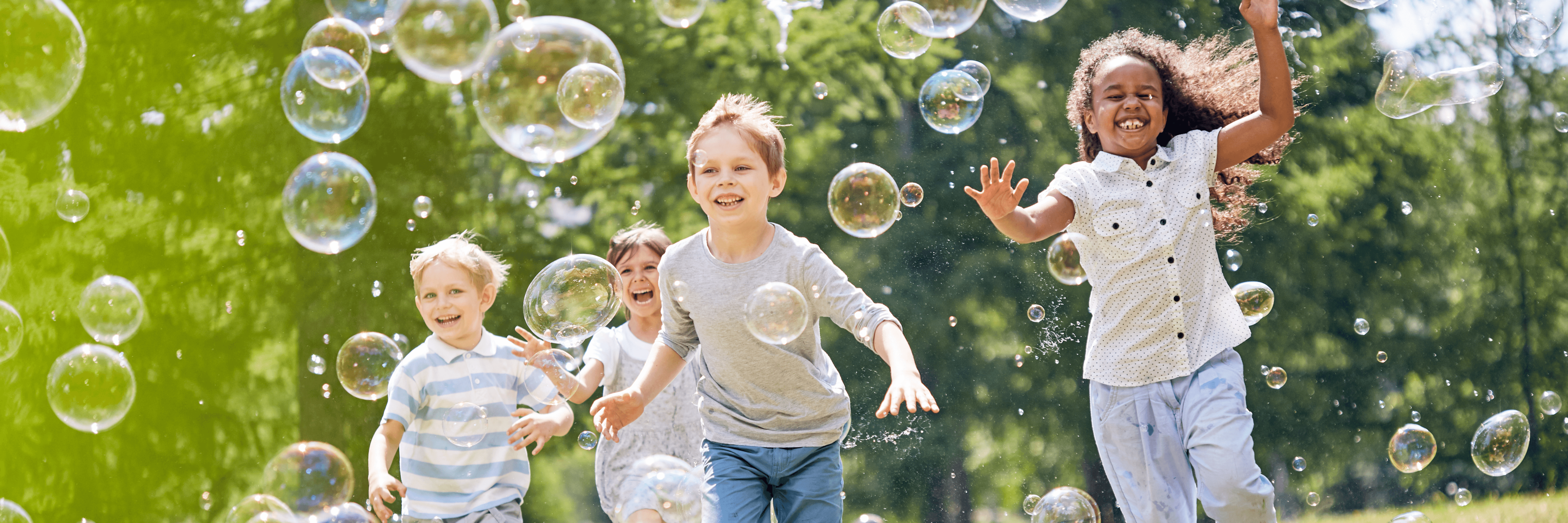 photo of children playing with bubbles outside